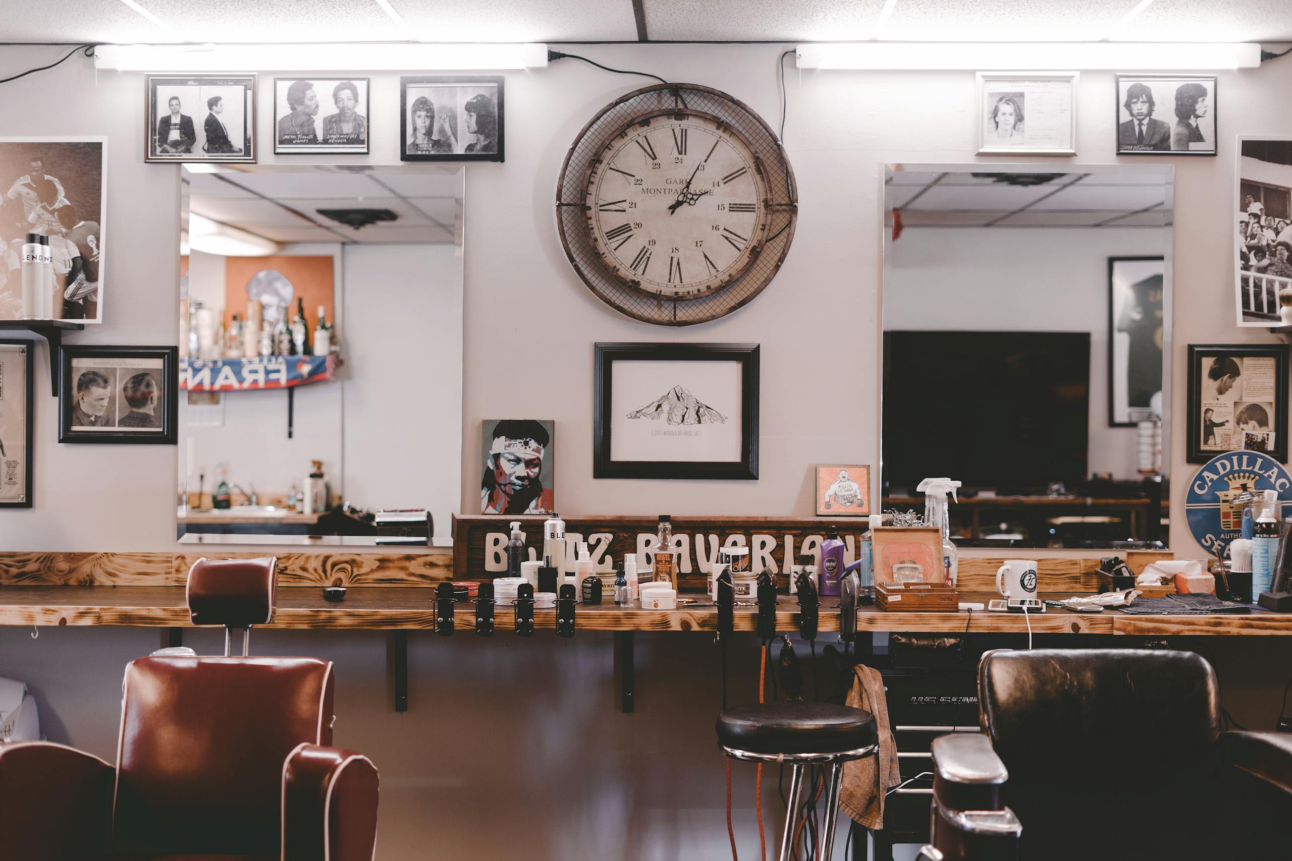 Stylish cozy interior design of modern hairdressing studio or barbershop with leather chairs stylish souvenirs and framed photos on walls